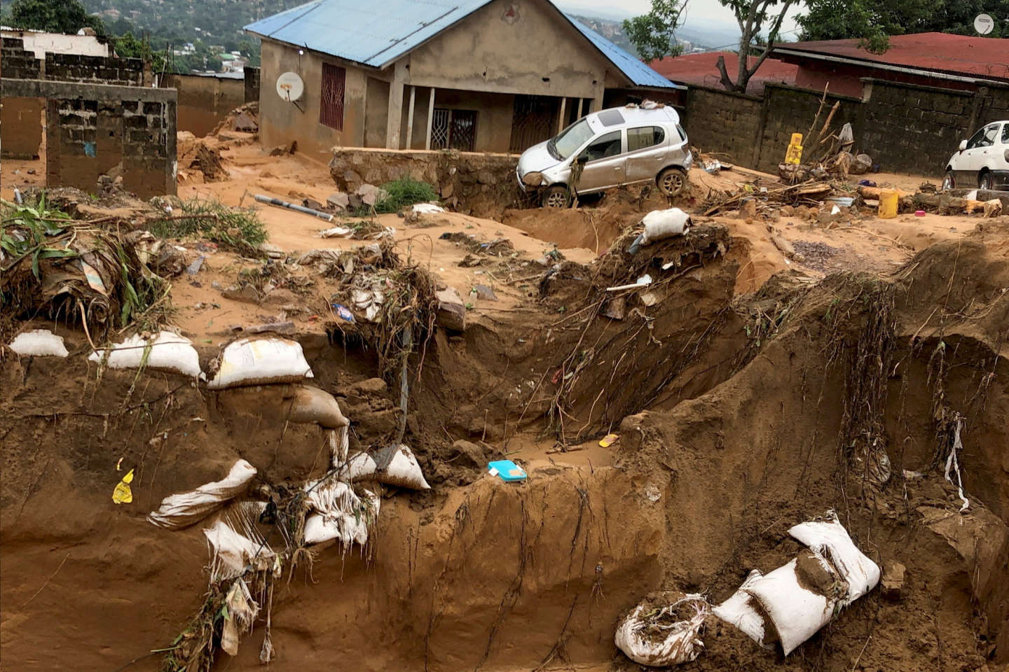 A car is seen stuck after heavy rains caused floods and landslides, on the outskirts of Kinshasa,